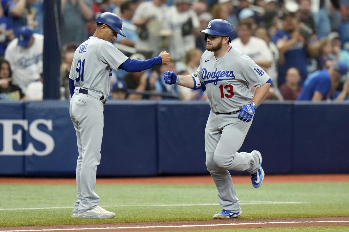 Max Muncy is congratulated by third base coach Dino Ebel after hitting a solo home run in the second inning.