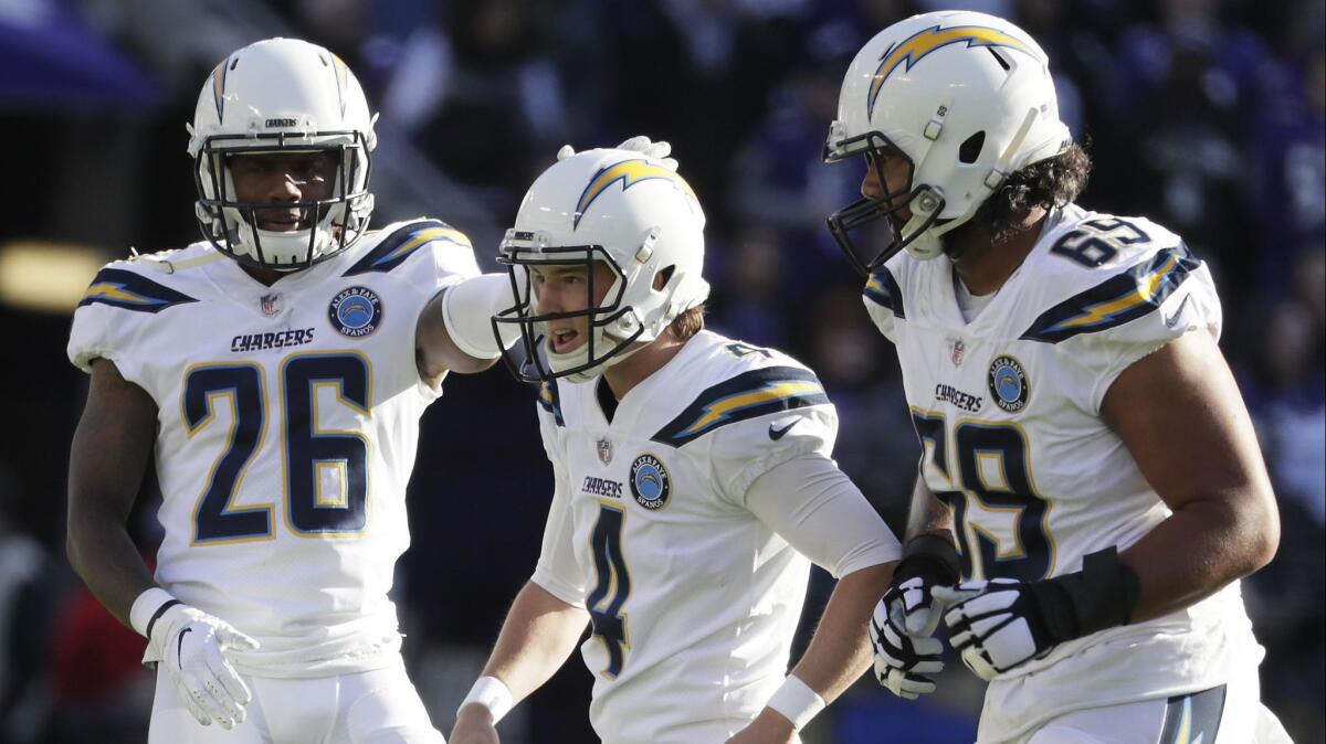 Chargers kicker Michael Badgley celebrates with teammates Casey Hayward Jr., left, and Sam Tevi after hitting a 53-yard field goal in a wild-card playoff game against the Baltimore Ravens in January.