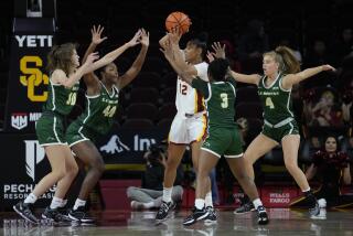 Southern California guard JuJu Watkins (12) is defended by Le Moyne guard Sydney Lusher.