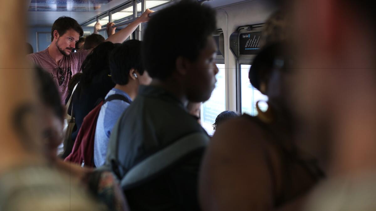 Commuters pack an eastbound Expo Line train into downtown Los Angeles.