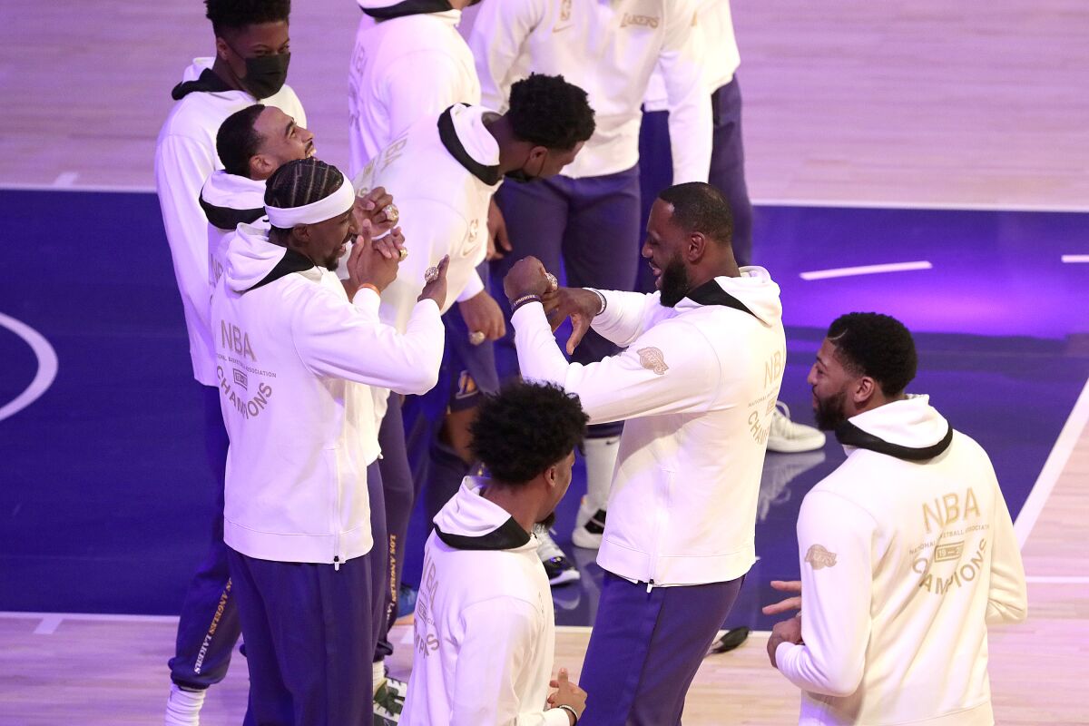 LeBron James celebrates with teammates after receiving a championship ring.