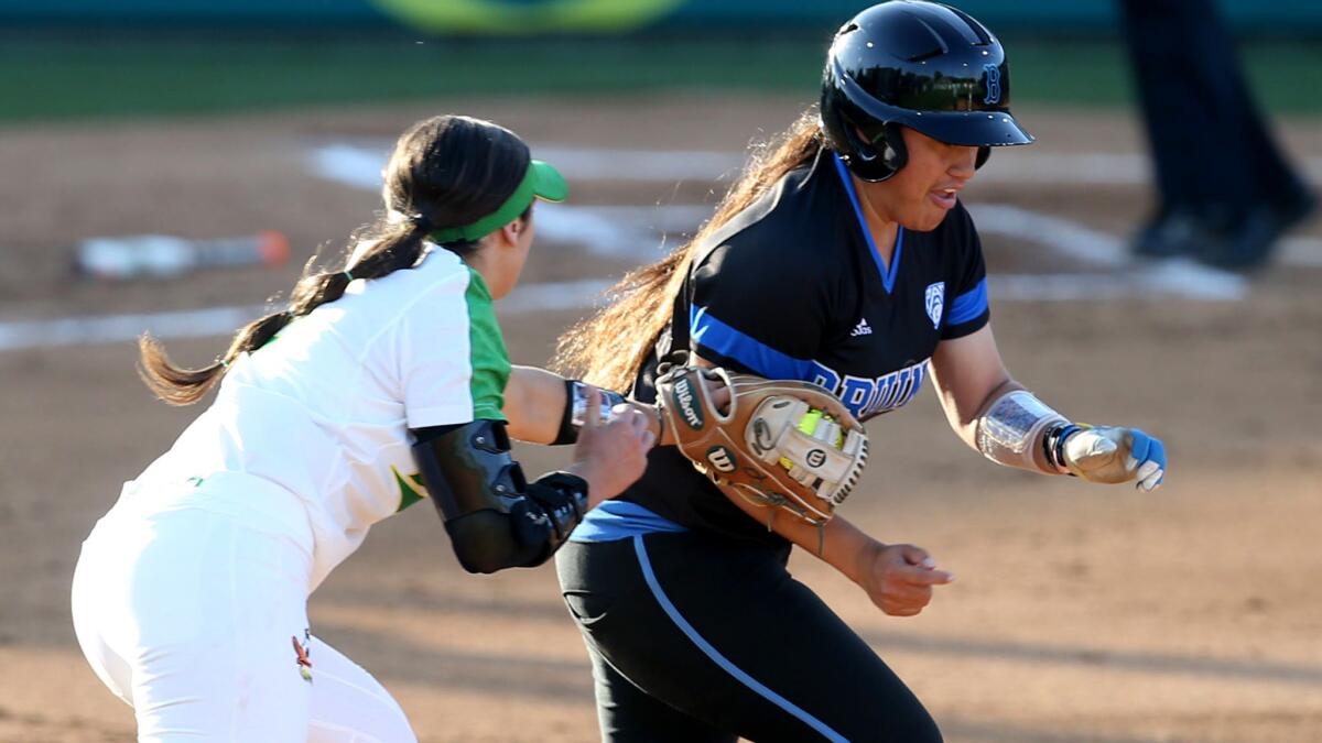 UCLA¿s Brianna Tautalafua is tagged out by Oregon¿s Lauren Lindvall while trying to advance to second base during the second inning Saturday.