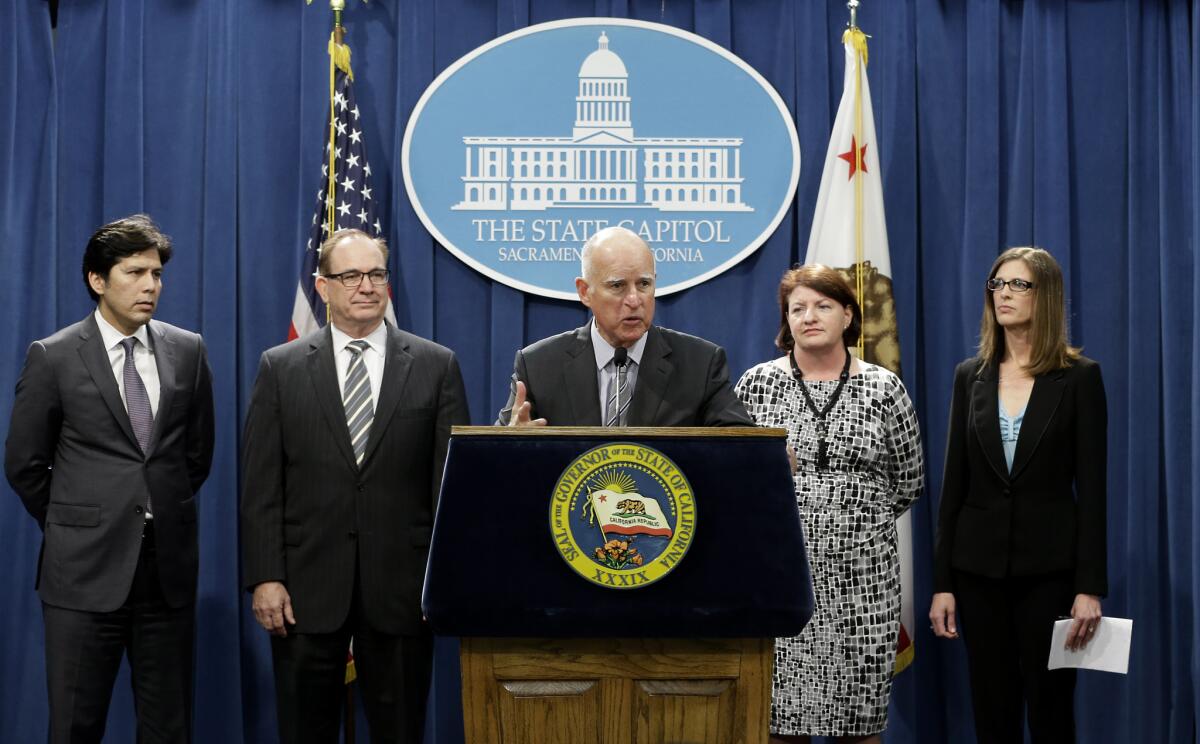 Gov. Jerry Brown, flanked by legislative leaders from both parties, discusses a $1-billion plan for water projects and drought relief on March 19.