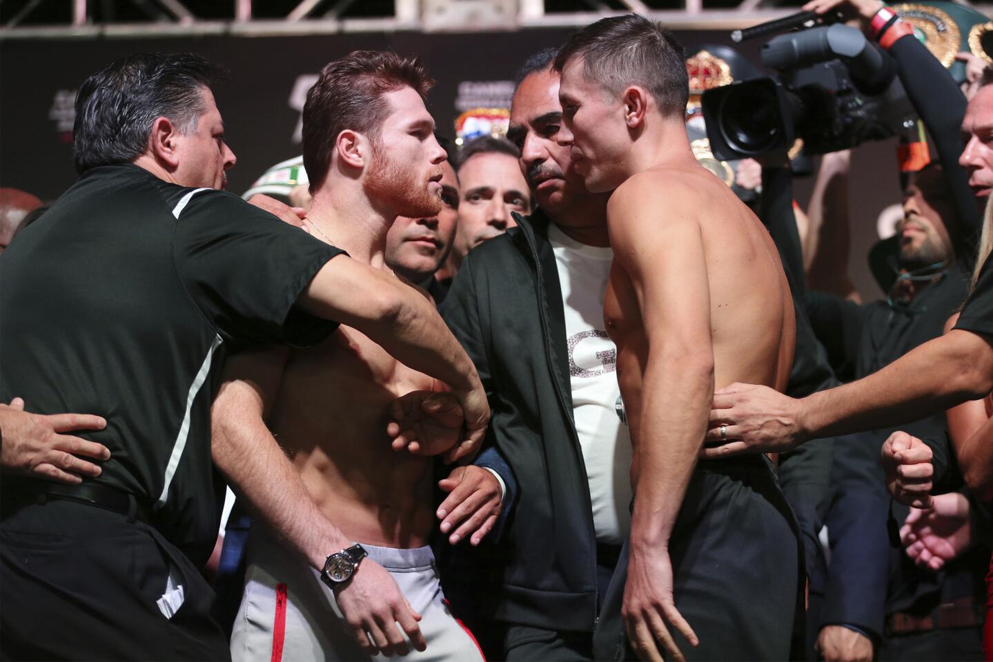 Canelo Alvarez, center left, and Gennady Golovkin face off during a weigh-in at T-Mobile Arena in Las Vegas, Friday, Sept. 14, 2018. Alvarez and Golovkin will fight Saturday night in a middleweight title bout. (Erik Verduzco/Las Vegas Review-Journal via AP)