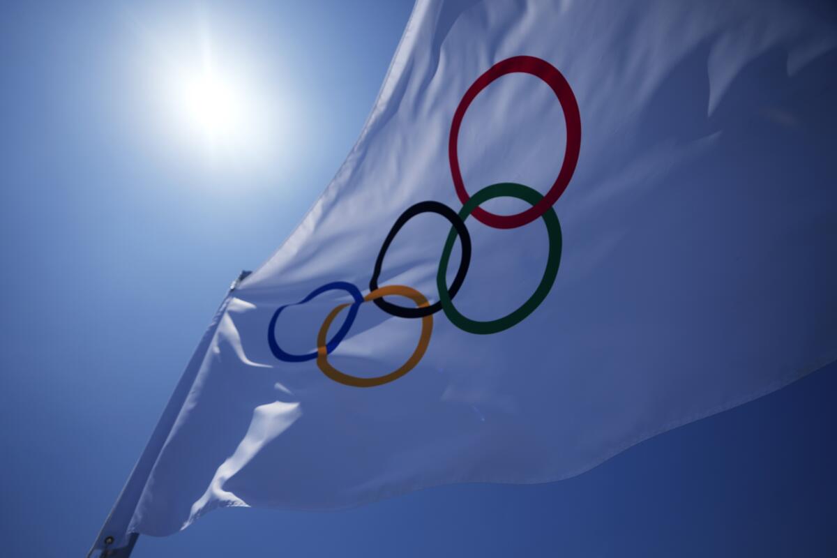 An Olympic flag flies over the top of the bleachers at Ariake Tennis Center on Monday.