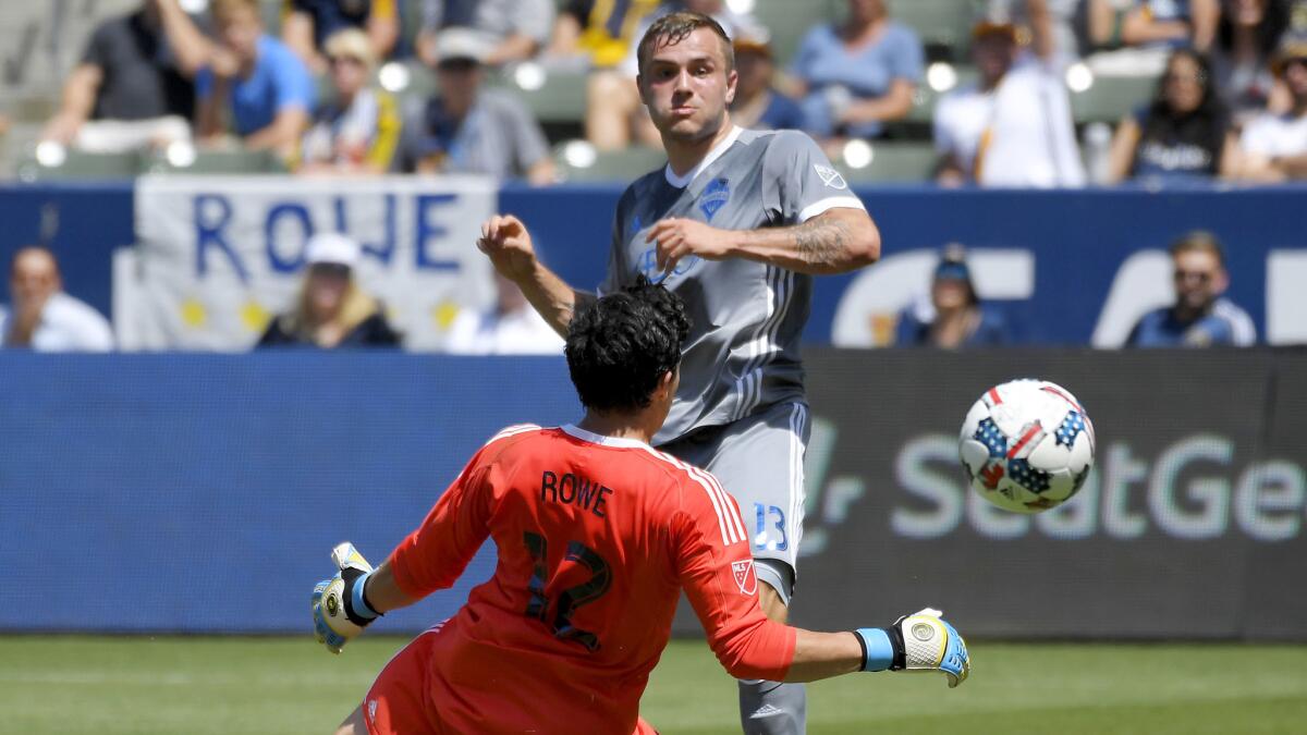 Sounders forward Jordan Morris chips a shot past Galaxy goalkeeper Brian Rowe for a score during the first half Sunday.