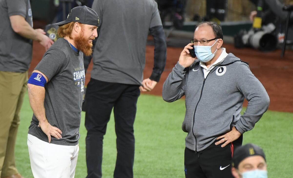 Justin Turner waits to talk to an unidentified man after Game 6 of the World Series.