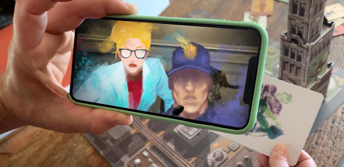 Hand holds smartphone with two animated people's faces on it.