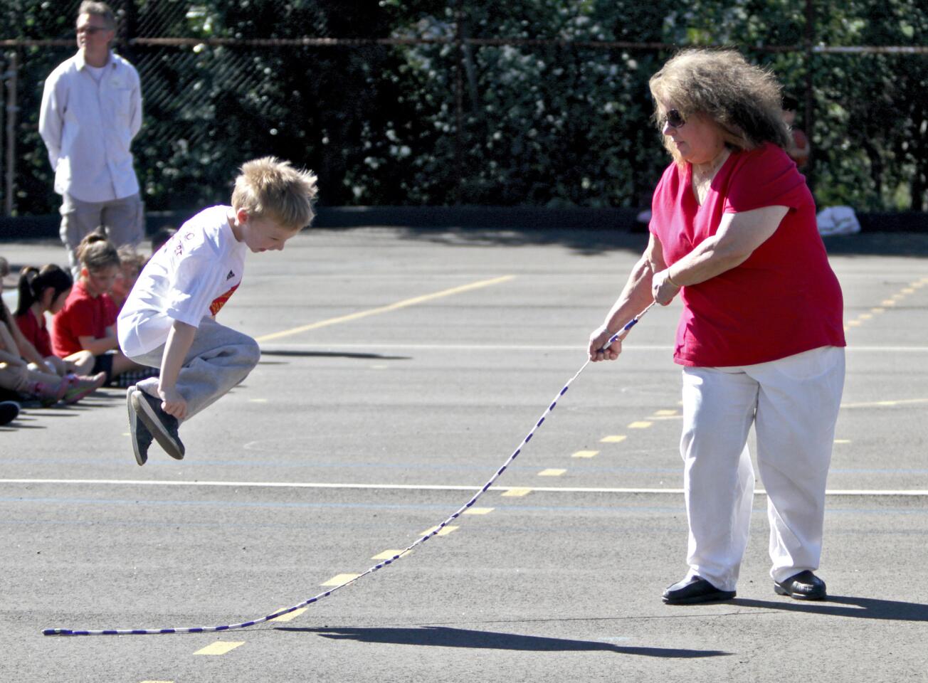 Education Assistant Sharon Padilla helps kindergartener Arthur McArdley jump rope for the Dunsmore Elementary School Jump Rope for Heart event to benefit the American Heart Assn. on Tuesday, Feb. 9, 2016. Children from all class levels at the school jumped rope for about half an hour.