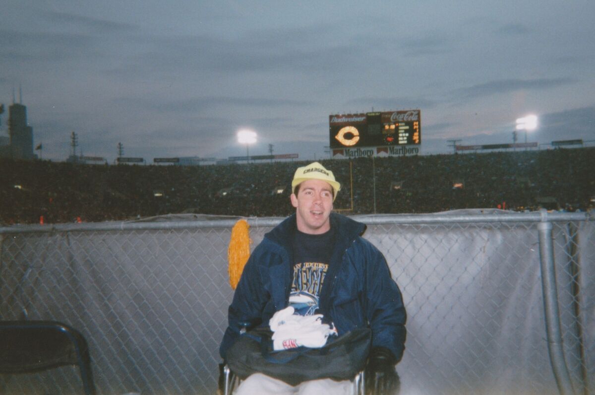 Brian Gushue of San Diego uses a wheelchair for the very first time at a Chargers-Bears football game in 1996.