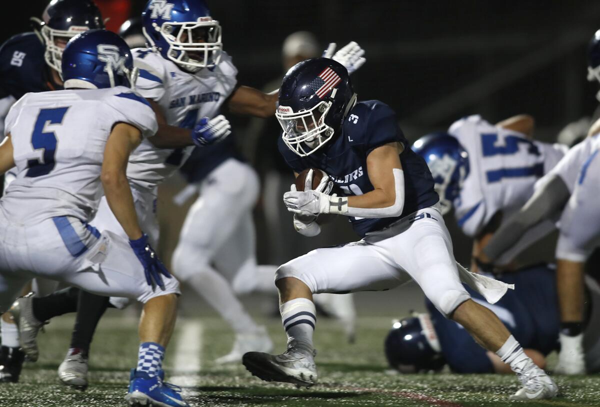 Newport Harbor running back Justin Starnes carries the ball against San Marino during the second quarter on Friday.
