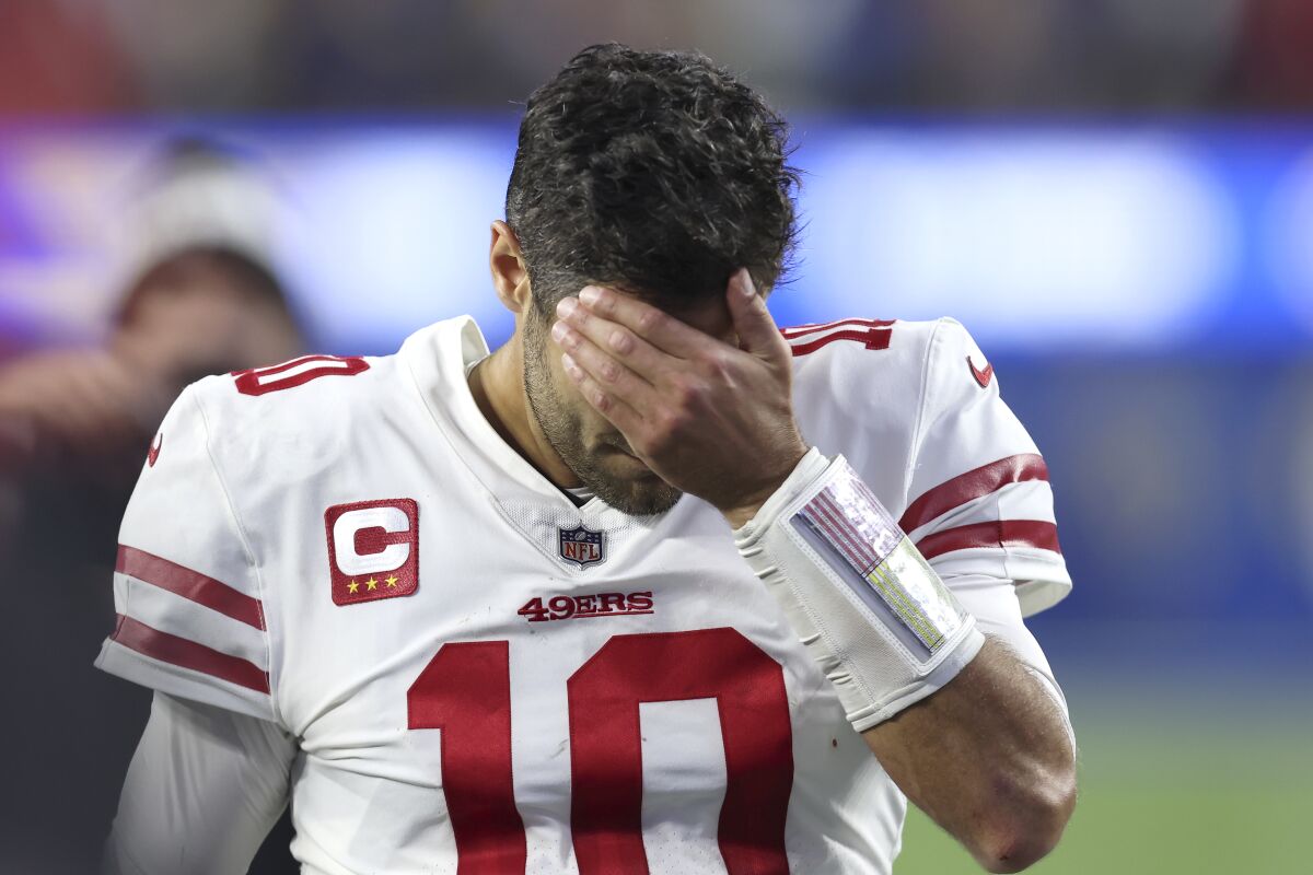 San Francisco 49ers' Jimmy Garoppolo walks off the field after the NFC Championship NFL football game against the Los Angeles Rams Sunday, Jan. 30, 2022, in Inglewood, Calif. The Rams won 20-17 to advance to the Super Bowl. (AP Photo/Jed Jacobsohn)