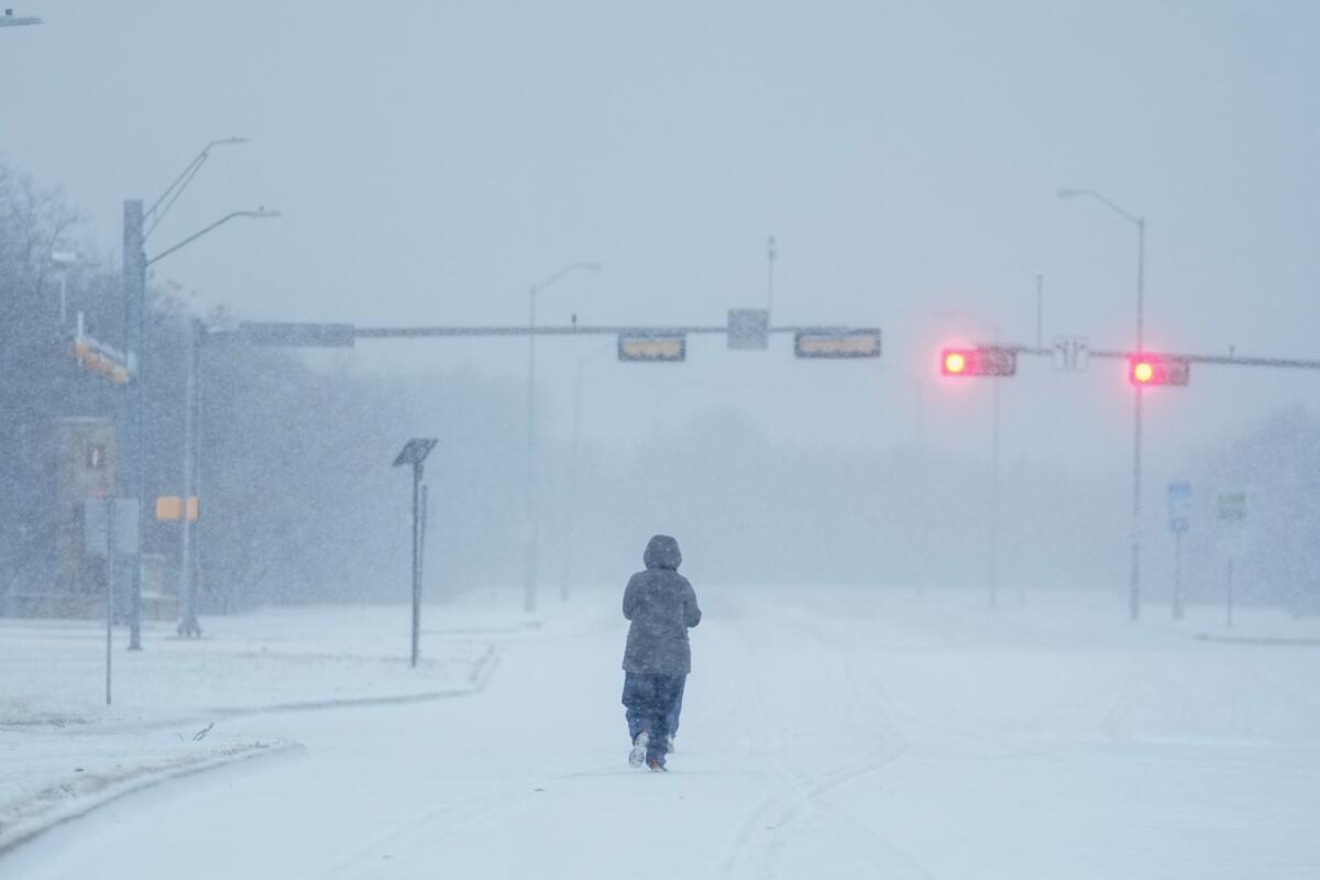 Jogger on a snow-covered road in Grand Prairie, Texas