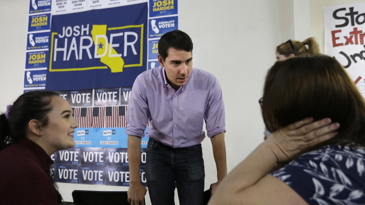 Josh Harder talks with supporters in Modesto on Oct. 25.