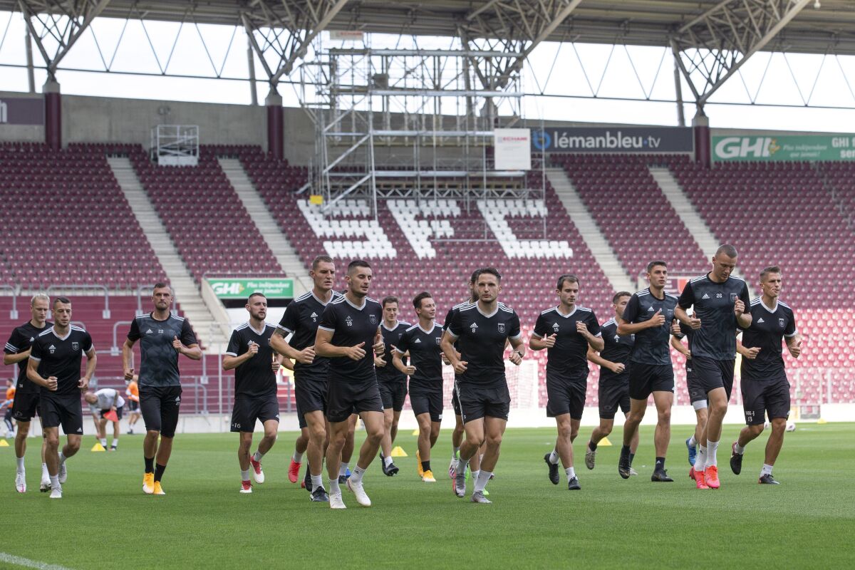 Slovakia's MFK Ruzomberok team warm up during a training session one day ahead of their UEFA Europa League first round qualifying soccer match against the Switzerland's team of Servette FC, at the Stade de Geneve stadium, in Geneva, Switzerland, Wednesday, Aug. 26, 2020. (Salvatore Di Nolfi/Keystone via AP)