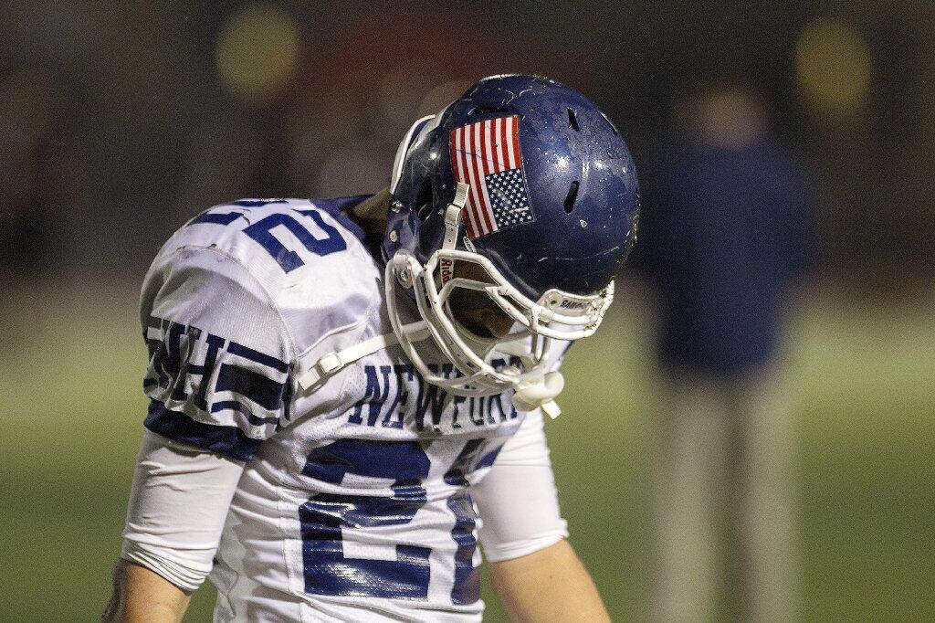 Newport Harbor's Max Durante hangs his head following a loss to Huntington Beach on Friday.