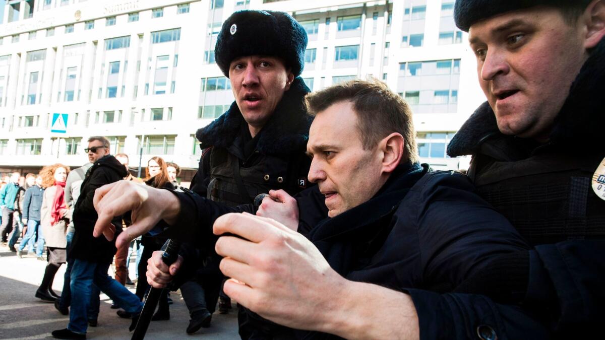 This handout picture taken and provided by Evgeny Feldman for Alexei Navalny's campaign on March 26, 2017, shows police officers detaining Navalny during an unauthorized anti-corruption rally in central Moscow. (Handout / AFP/Getty Images)