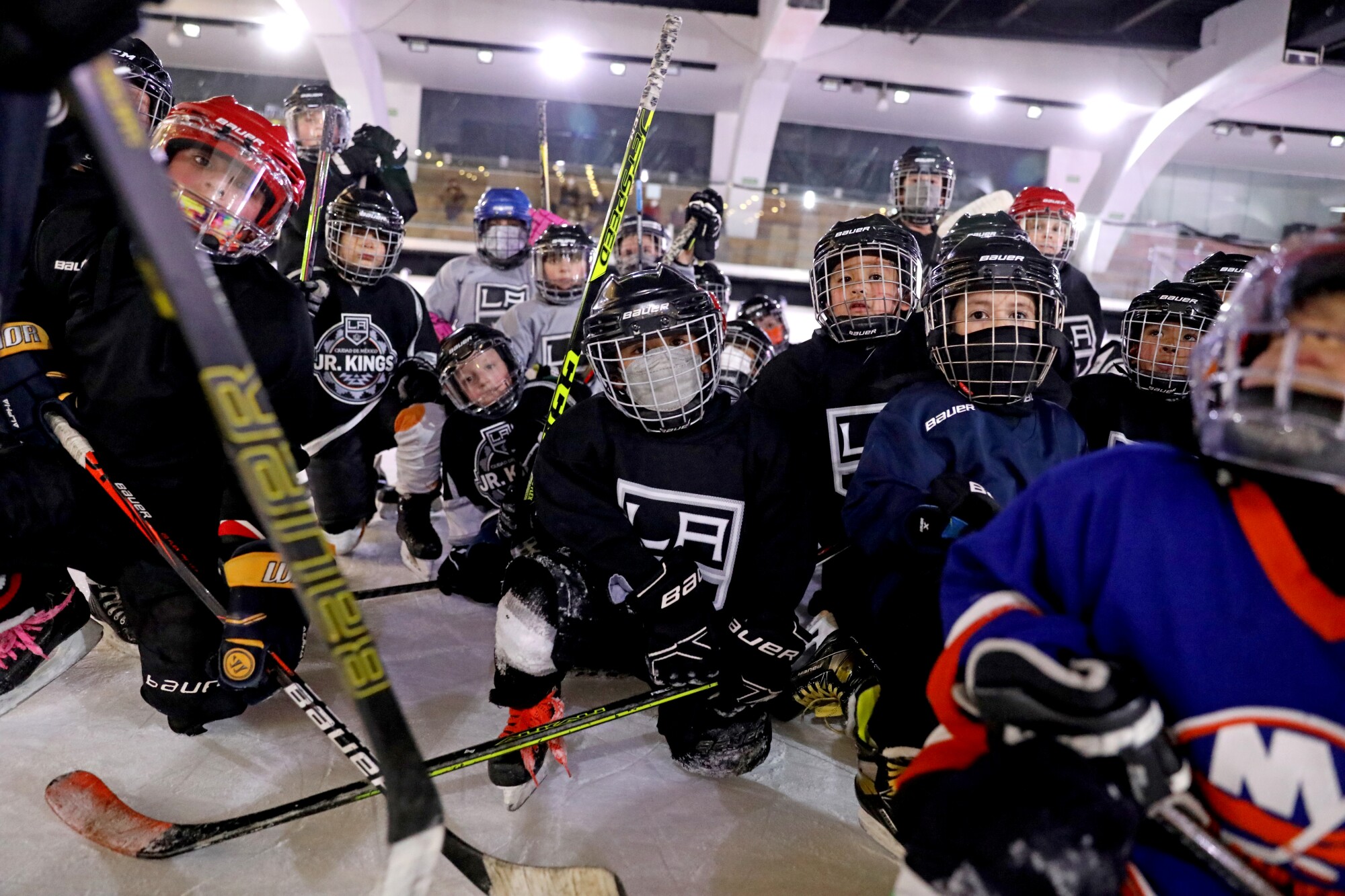 Players with the Mexico City Jr. Kings youth hockey program gather at the end of practice.