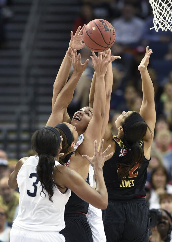 UConn center Kiah Stokes (41) fights for a rebound against Maryland center Brionna Jones (42) and Maryland center Malina Howard (5) as UConn forward Morgan Tuck (3) stands by. The UConn women beat Maryland 81-58 in the national semifinals Sunday night and will meet Notre Dame in the national championship game Tuesday.
