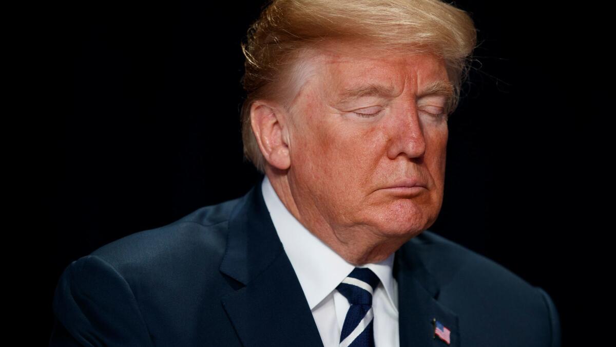 President Donald Trump prays during the National Prayer Breakfast in Washington on Feb. 8.