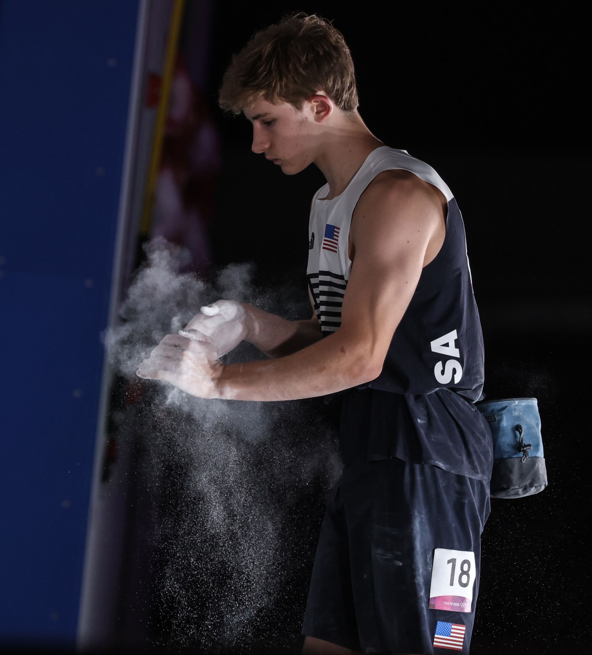 USA climber Danny Duffy rubs chalk on his hands before the men's combined bouldering final.