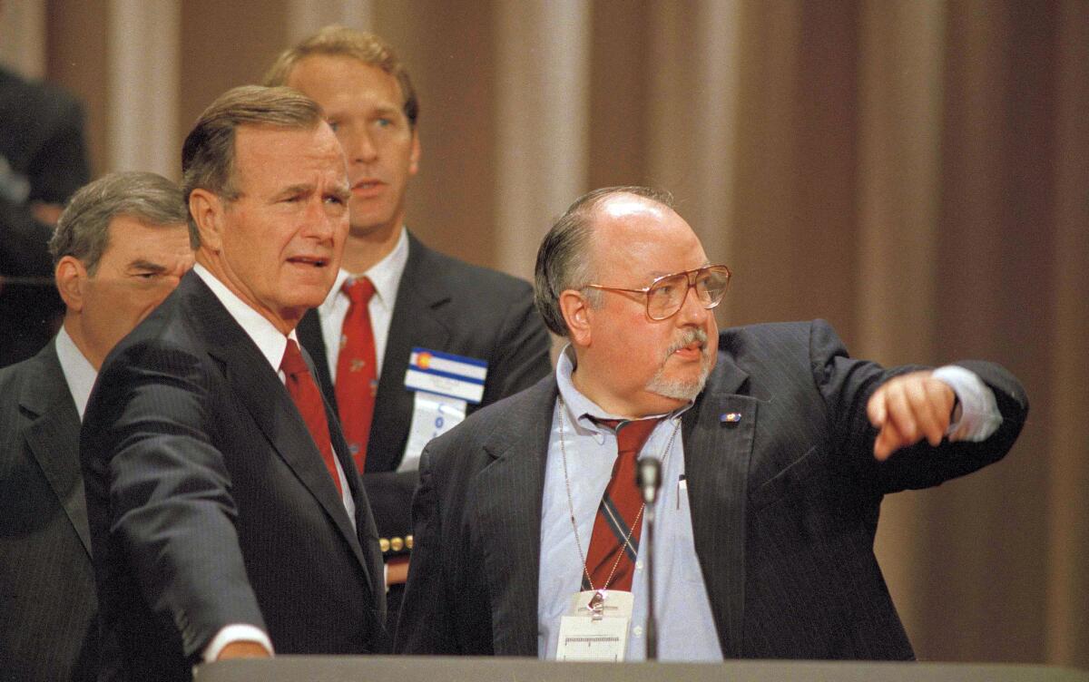 Vice President George H.W. Bush, left, gets some advice from his media advisor, Roger Ailes, behind the podium at the Superdome in New Orleans prior to the start of the Republican National Convention on Aug. 17, 1988.