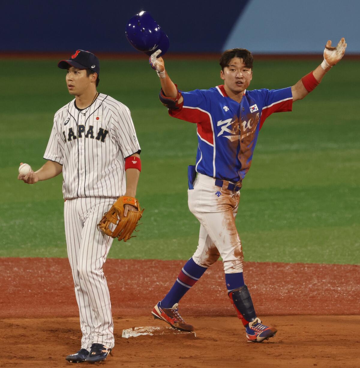 South Korea outfielder Hae Min Park celebrates next to Japan infielder Tetsuto Yamada.