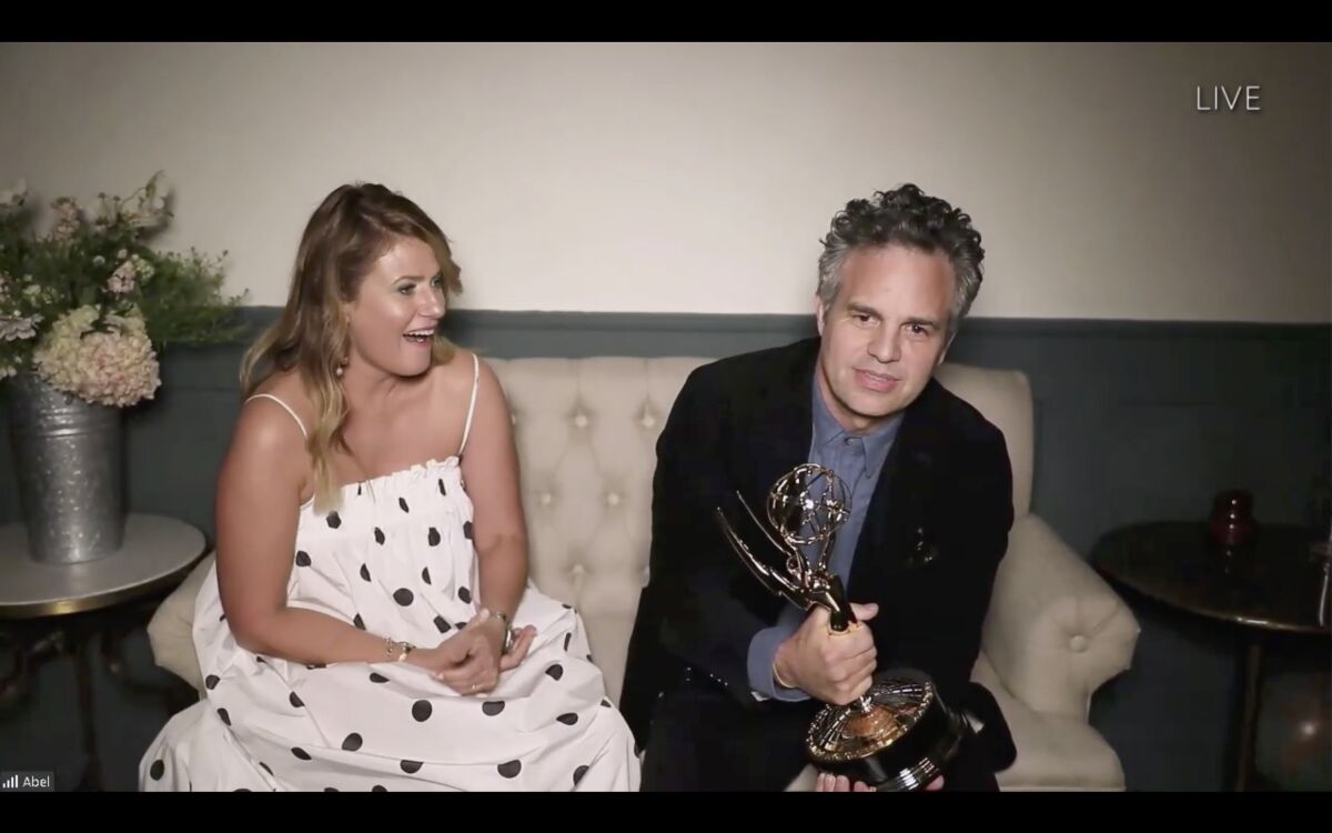 Mark Ruffalo accepts his Emmy as wife Sunrise Coigney looks on