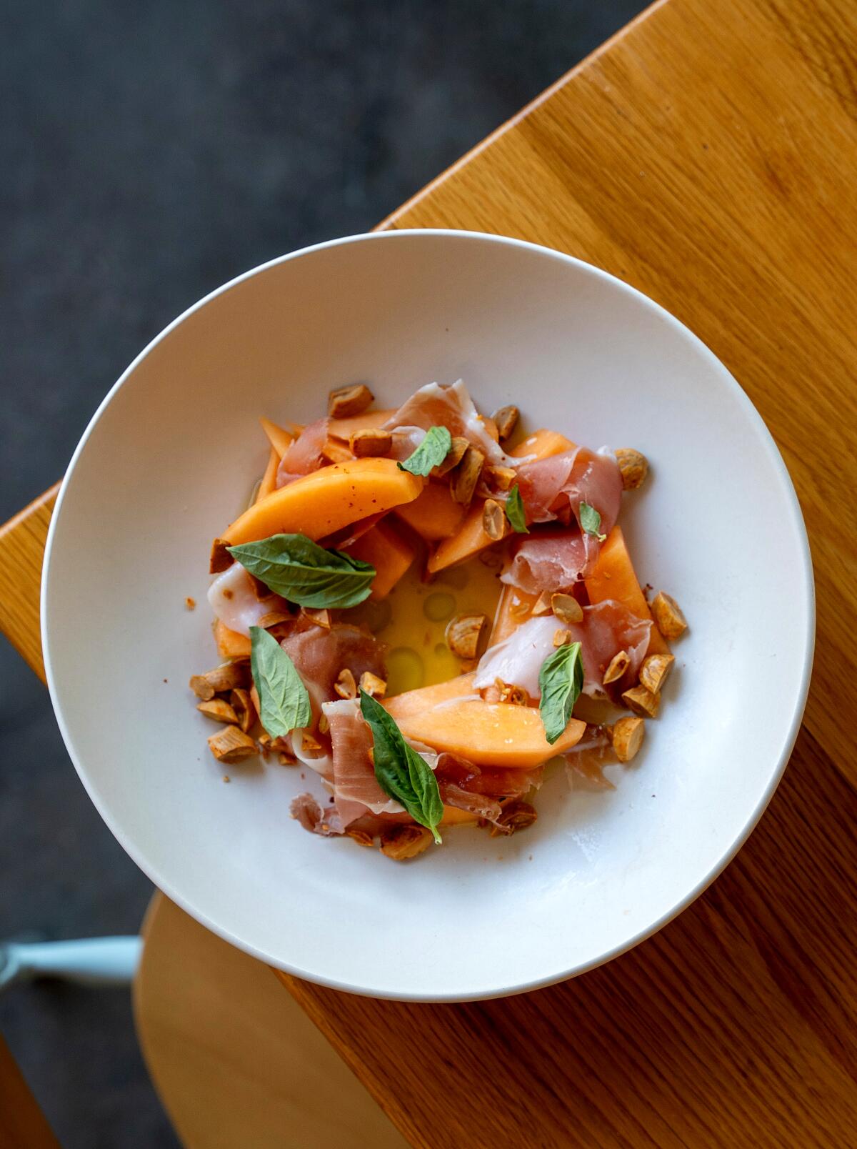 Weiser Family Farm Melon & Prosciutto Cured speck, melon vinaigrette, basil & Aleppo spiced marcona almonds.