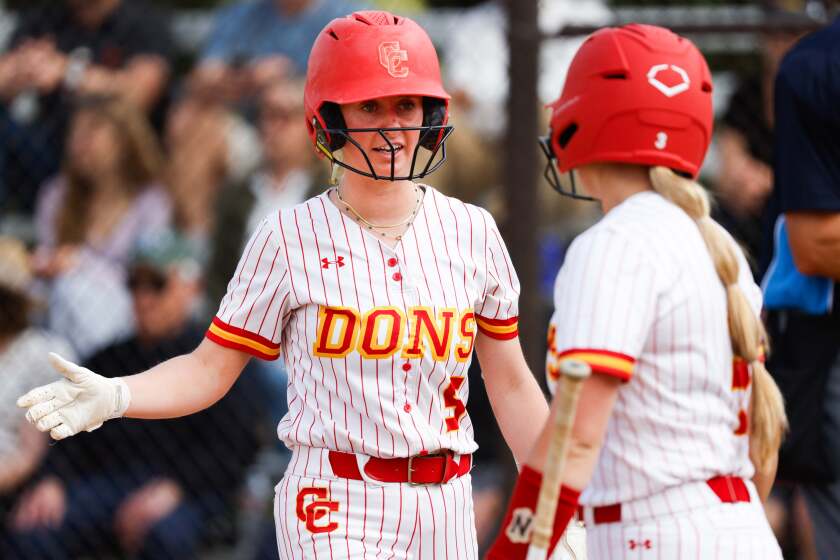San Diego, CA - May 14: Cathedral Catholic's Shea Johnson and Ava Torre celebrate a run scored against Torrey Pines during their game at Cathedral Catholic High School on Tuesday, May 14, 2024 in San Diego, CA. (Meg McLaughlin / The San Diego Union-Tribune)