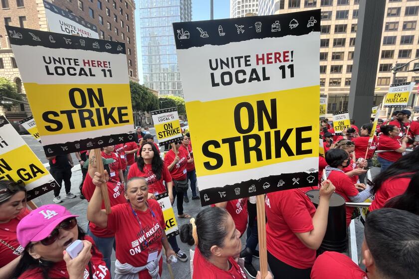 Los Angeles, CA - July 02: Hotels workers walk a picket line on Sunday, July 2, 2023 in Los Angeles, CA. Thousands of workers at hotels across Southern California walked off the job early Sunday demanding higher pay and better benefits, beginning what could be the largest U.S. hotel workers' strike in recent memory.(Genaro Molina / Los Angeles Times)