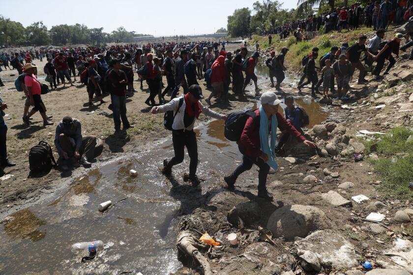 Mandatory Credit: Photo by Esteban Biba/EPA-EFE/REX (10531237n) Hundreds of Central American migrants, mostly Hondurans, cross the Suchiate River that divides Mexico and Guatemala, from the city of Tecun Uman, Guatemala, 20 January 2020. A migrant caravan consisting of Central Americans at the border of Guatemala announced that they would postpone their crossing from 19 to 20 January because they still wait for other partners, with whom they estimate to add between 5,000 and 8,000 people. Migrants cross into Mexico along the Suchíate river after denial of entry, Tecun Uman, Guatemala - 20 Jan 2020 ** Usable by LA, CT and MoD ONLY **