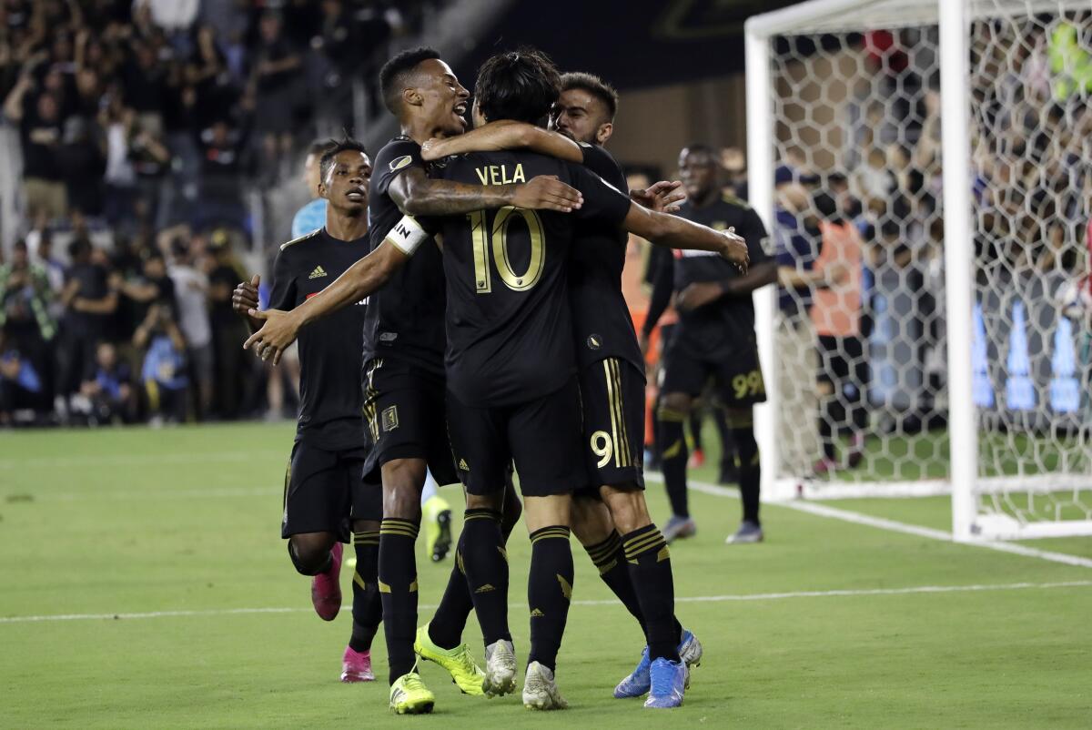LAFC's Carlos Vela celebrates with teammates after scoring during the second half of Sunday's 3-3 tie with the Galaxy.