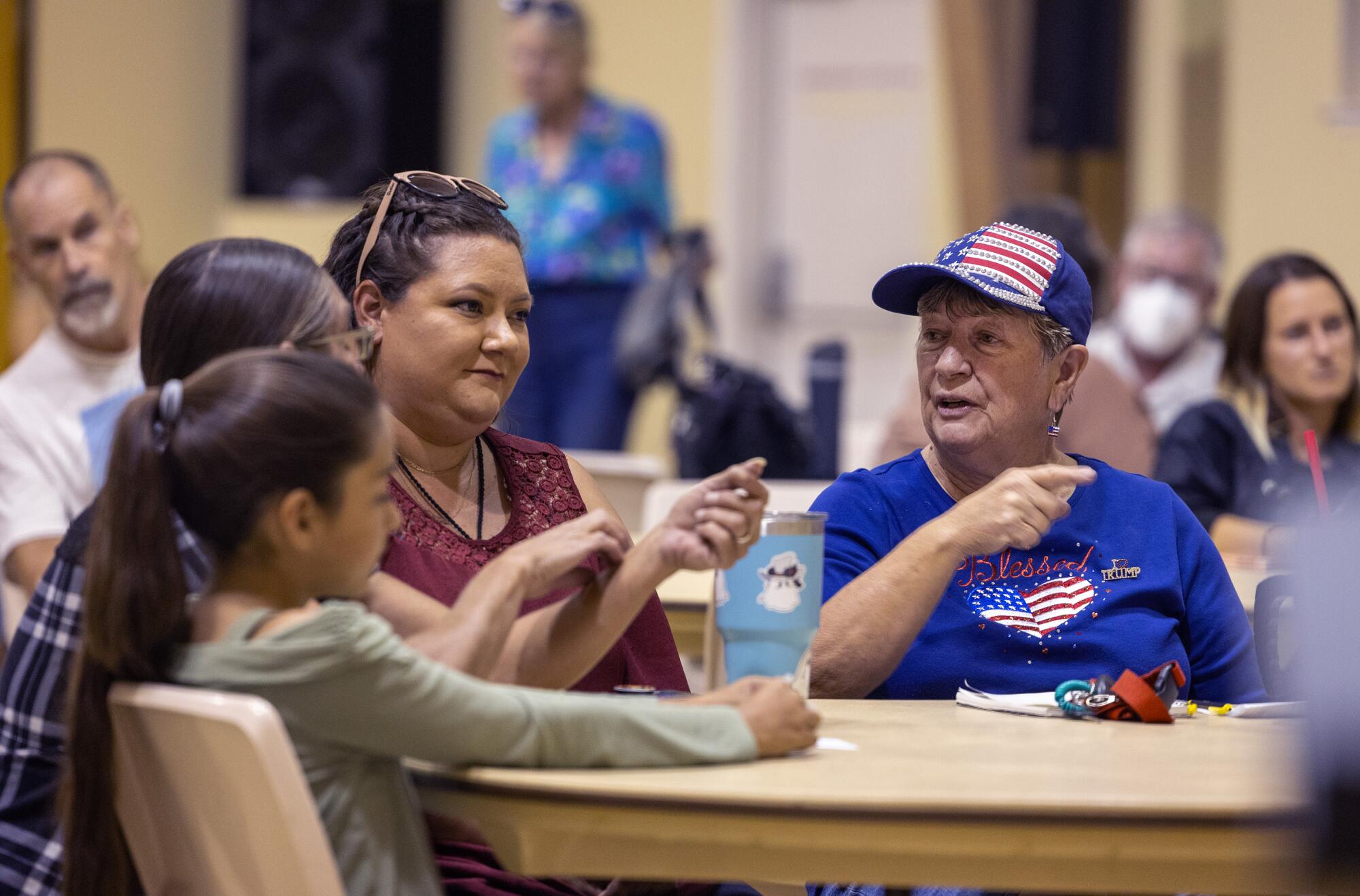 Lynette McIntosh, right, talks with others attending a Bishop City Council candidate forum on Oct. 2, 2024.