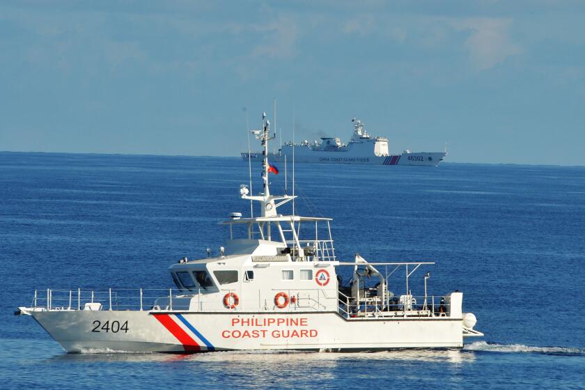 This photo taken on May 14, 2019, a Philippine coast guard ship (R) sails past a Chinese coastguard ship during an joint search and rescue exercise between Philippine and US coastguards near Scarborough shoal, in the South China Sea. - Two Philippine coastguard ships, BRP Batangas and Kalanggaman and US coastguard cutter Bertholf participated in the exercise. (Photo by TED ALJIBE / AFP) (Photo credit should read TED ALJIBE/AFP via Getty Images)