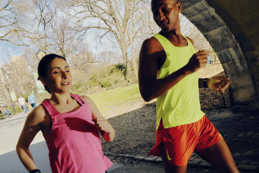 A marathon runner and her trainer on the trail in Central Park in New York.