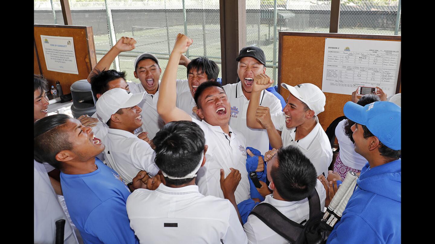 Fountain Valley High boys' tennis team celebrates defeating Temecula Great Oak, 11-7, in the CIF Southern Section Division 2 title match at The Claremont Club on Friday, May 18.