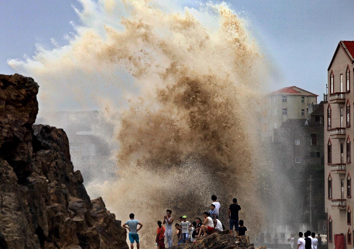 Residents gather to see huge waves stirred up by incoming Typhoon Soudelor in Wenling, China, on Aug. 8.