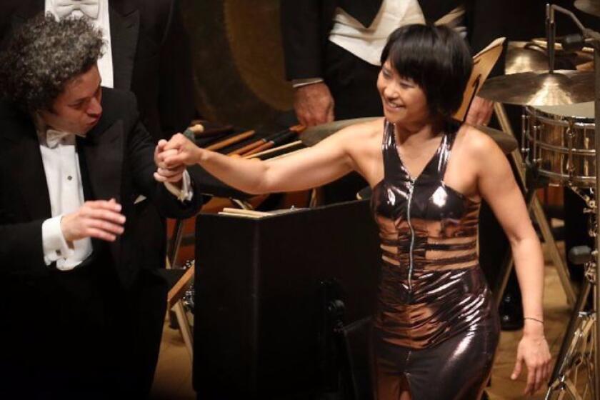 LOS ANGELES, CALIF. -- FRIDAY, MAY 26, 2017: Gustavo Dudamel, Los Angeles Philharmonic conductor, left, and pianist Yuja Wang receive a standing ovation after the performance in Bartók piano concerto with the Los Angeles Philharmonic at the Walt Disney Concert Hall in Los Angeles, Calif., on May 26, 2017. Gustavo Dudamel now begins a two-week cycle of three Bartók piano concertos with Yuja Wang that also includes major works by Janácek (here the spectacular “Glagolitic Mass”) and Stravinsky (this week the composer’s rarely heard last major work, “Requiem Canticles”). (Allen J. Schaben / Los Angeles Times)