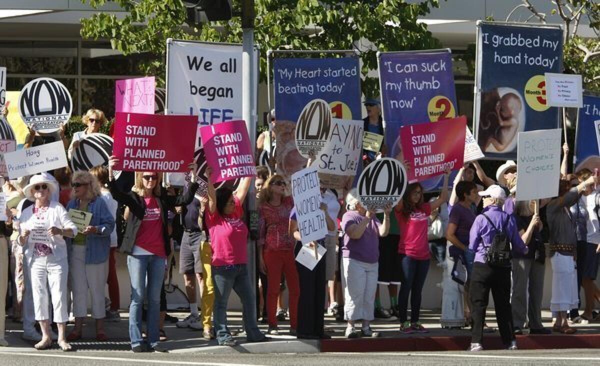 Demonstrators gather outside Hoag Hospital in 2012 to voice their opinion about the decision to halt elective abortions at Hoag Hospital.