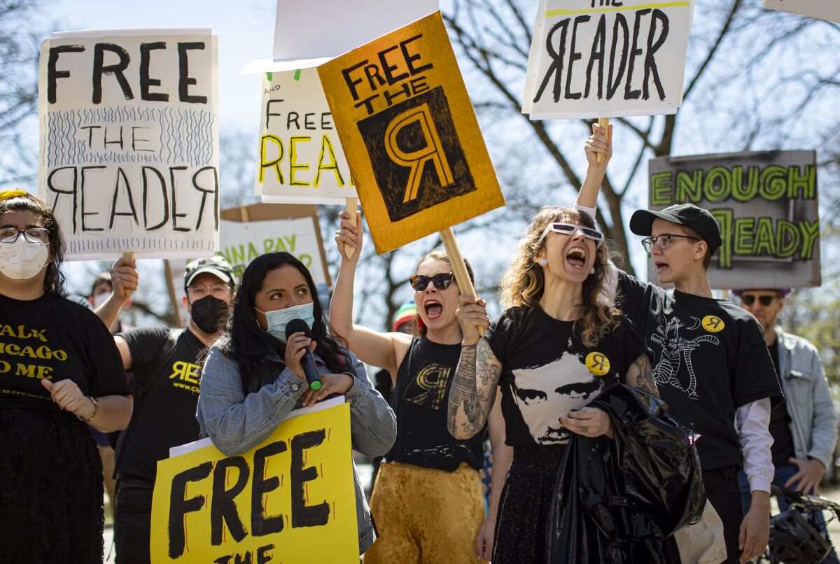 Staff and supporters of the Chicago Reader rally Thursday, April 21, 2022, outside the home of Reader investor Leonard Goodman. (Brian Cassella/Chicago Tribune via AP)