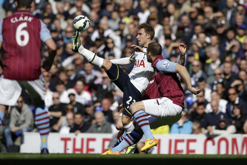 Tottenham Hotspur's Christian Eriksen, left, competes for the ball with Aston Villa's Tom Cleverley at White Hart Lane stadium in London on April 11.