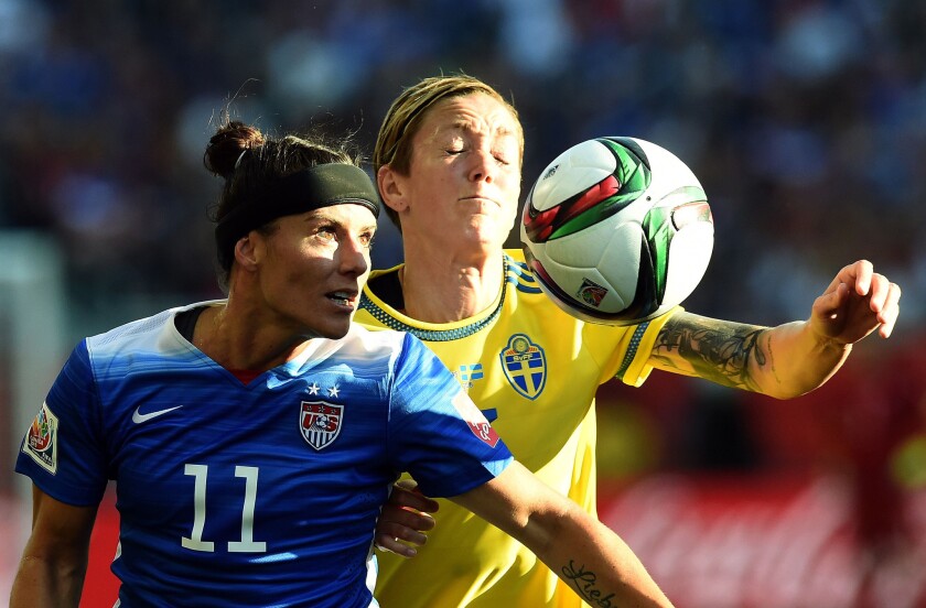 U.S. defender Ali Krieger and Sweden midfielder Therese Sjogran battle for possession of the ball during the first half of their group game on Friday at the Women's World Cup.