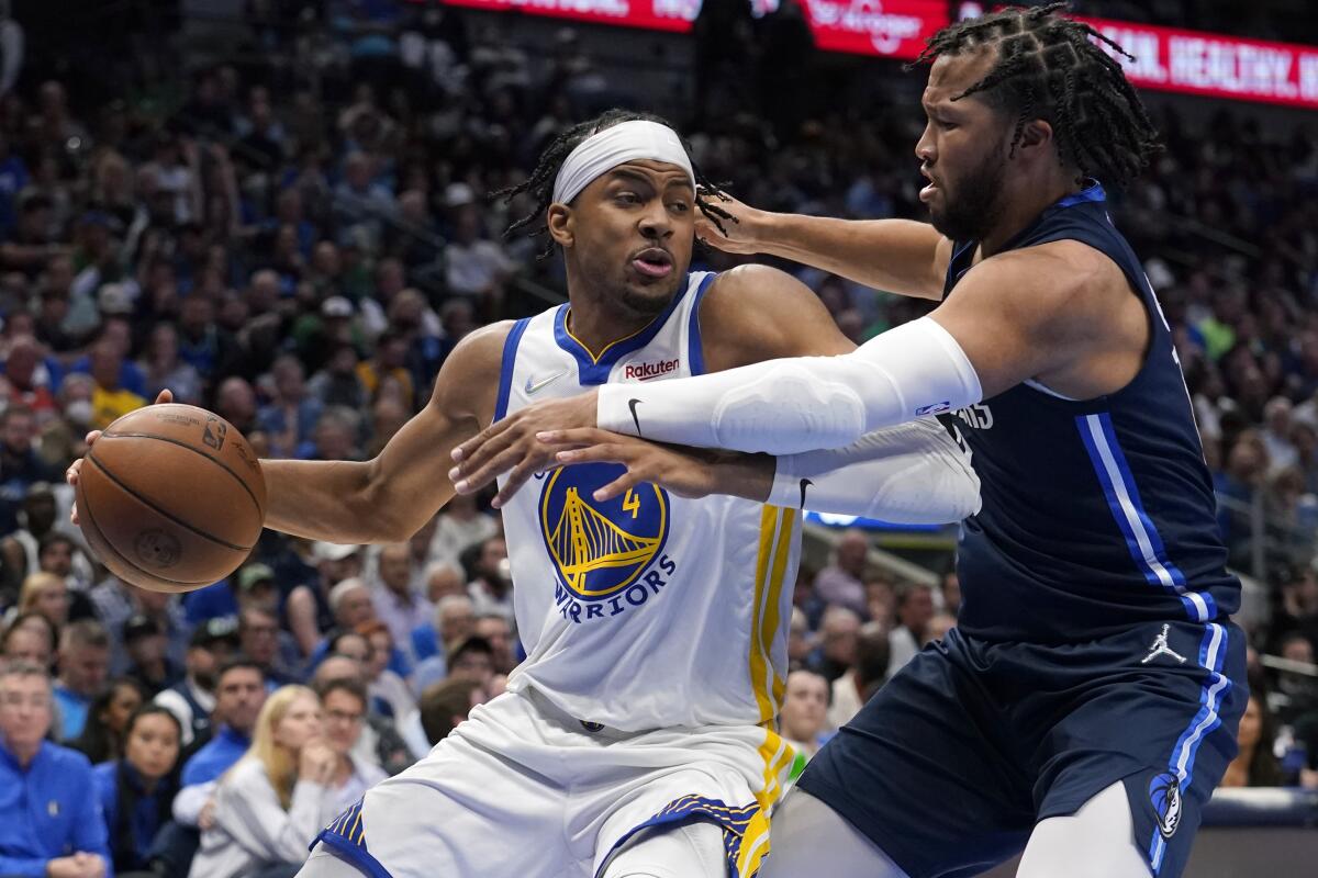 Golden State Warriors guard Moses Moody drives past Dallas Mavericks guard Jalen Brunson.