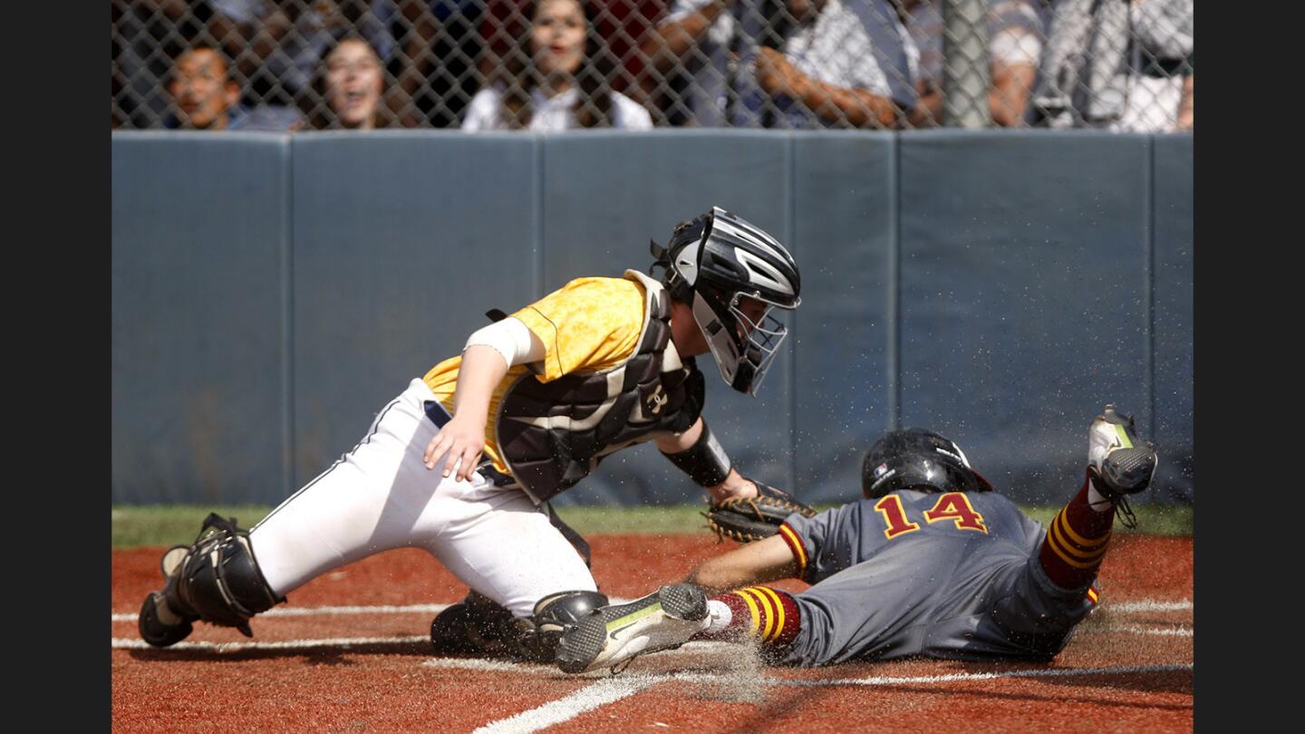 La Cañada High School baseball player #14 Matthew Sox (C) is tagged out at the plate by Campbell Hall High School's catcher #7 Cole Slater in CIF SS Div. 5 quarterfinal game at the Vikings home field in North Hollywood, on Friday, May 26, 2017. The Spartans lost 2-1 to the Vikings.