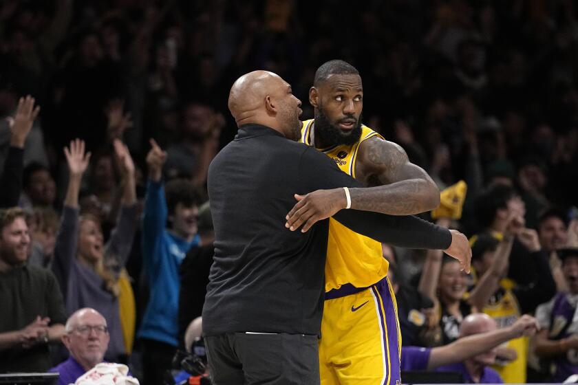 Los Angeles Lakers head coach Darvin Ham, left, hugs forward LeBron James after the Lakers defeated the New Orleans Pelicans 120-117 in overtime of an NBA basketball game Wednesday, Nov. 2, 2022, in Los Angeles. (AP Photo/Mark J. Terrill)