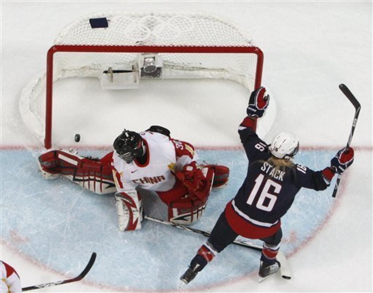 USA's forward Kelli Stack (16) celebrates after scoring past China's goal keeper Shi Yao (30) in the first period in women's preliminary round hockey play at the Vancouver 2010 Olympics in Vancouver, British Columbia, Sunday, Feb. 14, 2010. (AP Photo/Gene J. Puskar)