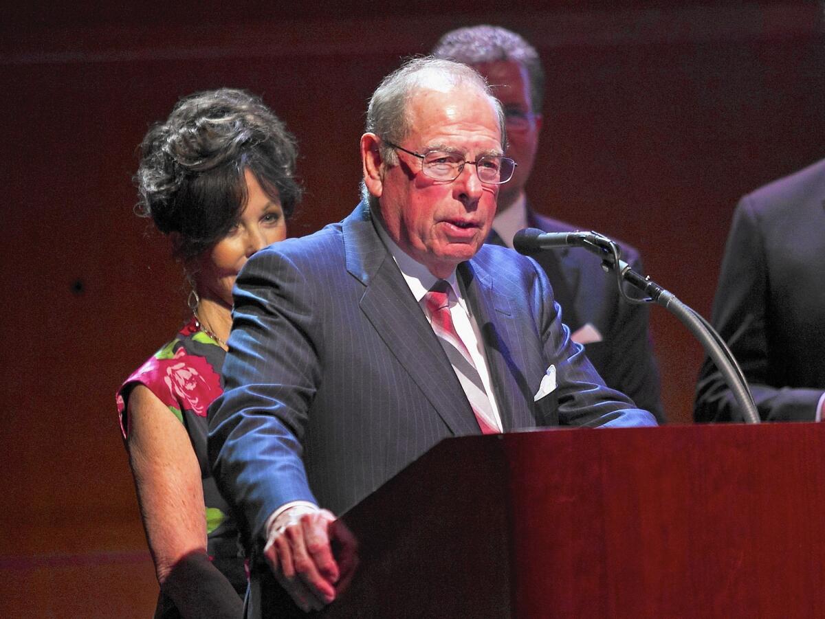 George Argyros, founder of Arnel and Affiliates and a former U.S. ambassador to Spain, speaks before receiving the Lifetime Achievement Award with his wife, Julia, left, during Costa Mesa's fourth annual Mayor's Celebration: The Art of Leadership dinner on Thursday at the Samueli Theater at the Segerstrom Center for the Arts.