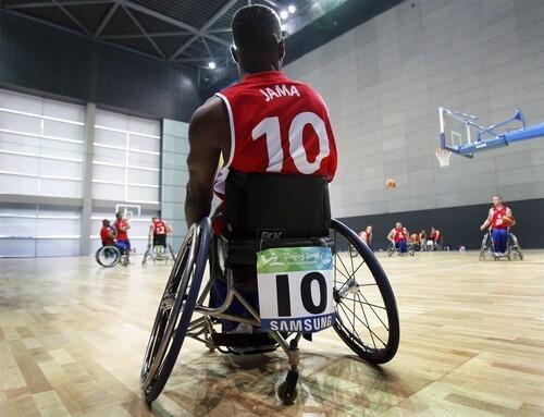 A British wheelchair basketball player watches his teammates during their training inside the National Indoor Stadium.