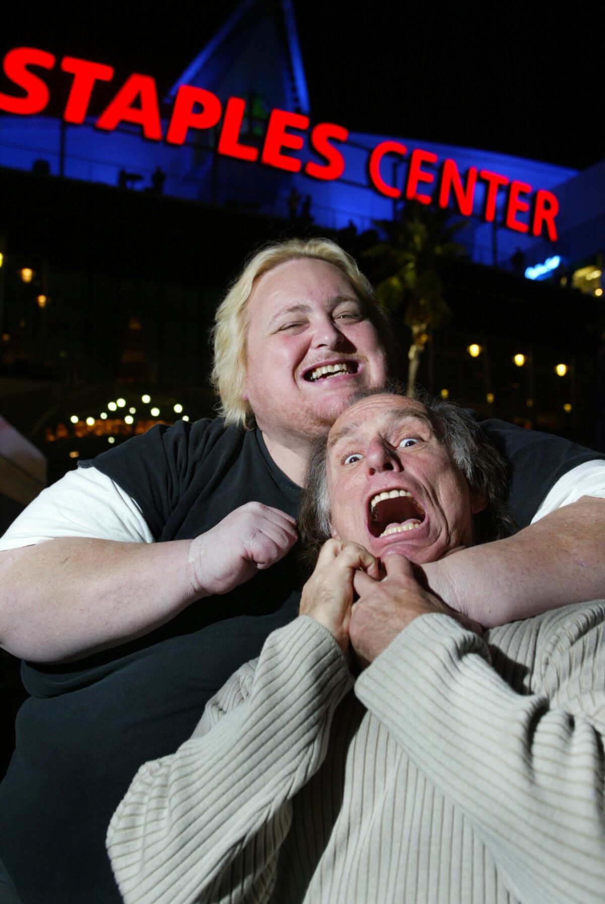 Sports talk radio personalities Joe McDonnell, left, and Doug Krikorian have a little fun outside Staples Center in 2004.